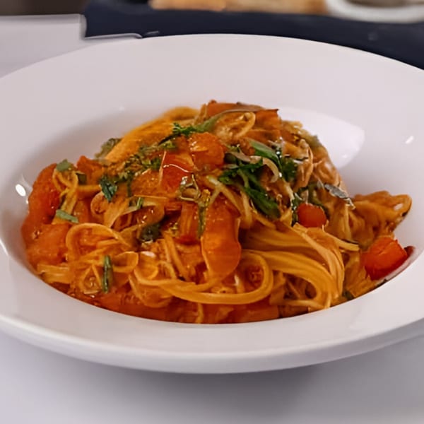 Cafe Arrivederci's Italian pasta dish with tomato sauce, fresh herbs, and vegetables.